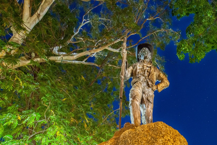 Nighttime image of Jack Jugarie statue in Halls Creek Memorial Park.